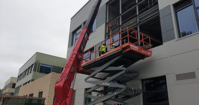 UNIC crane installs glass