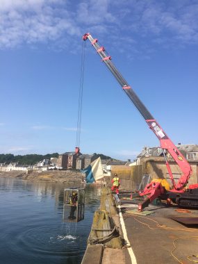 UNIC URW-706 Mini Spider Crane assisting with a pier refurbishment.