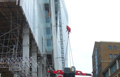 UNIC URW-706 Mini Spider Crane dismantled and being lifted by crane onto The Shard.