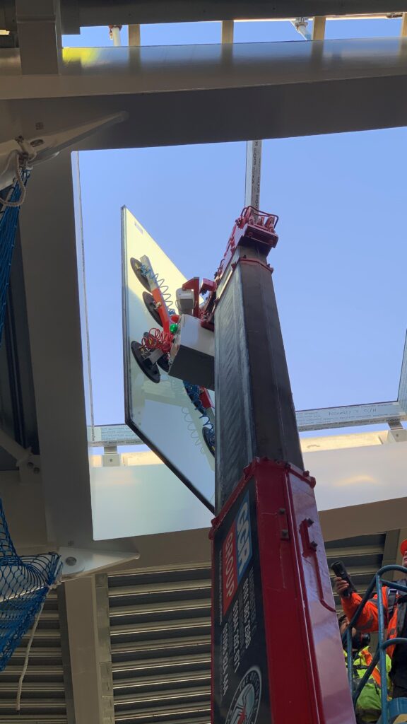 UNIC URW-506 Mini Spider Crane and GL-UMC 600 Glass Manipulator install glass roof panels for Wimbledon tennis club.