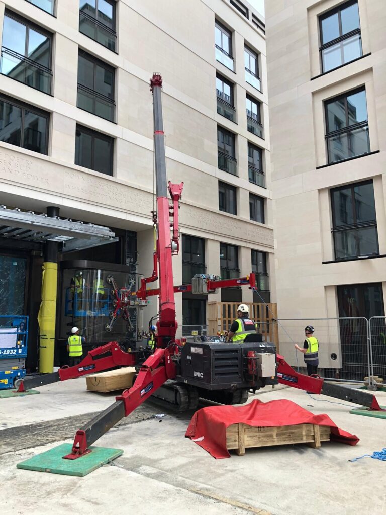 UNIC URW-706 Mini Spider Crane and Libro 1000 3D Head installing curved glazing units.