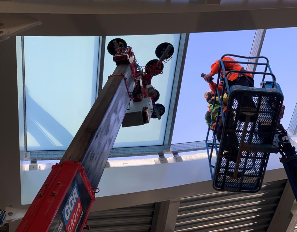 UNIC URW-506 Mini Spider Crane and GL-UMC 600 Glass Manipulator install glass roof panels for Wimbledon tennis club.