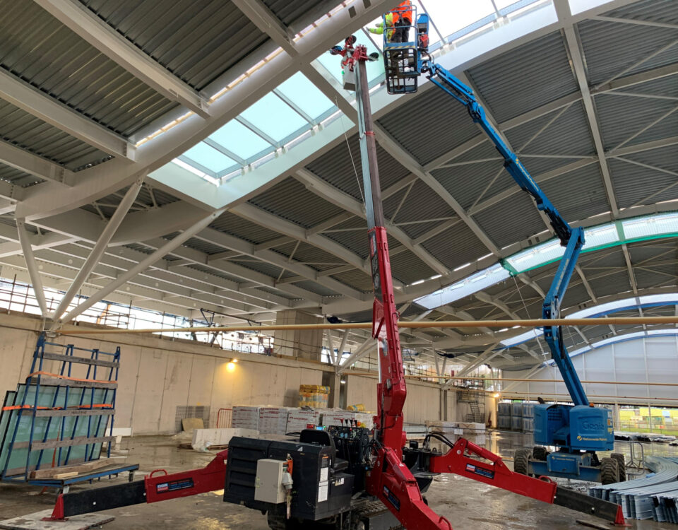UNIC URW-506 Mini Spider Crane and GL-UMC 600 Glass Manipulator install glass roof panels for Wimbledon tennis club.