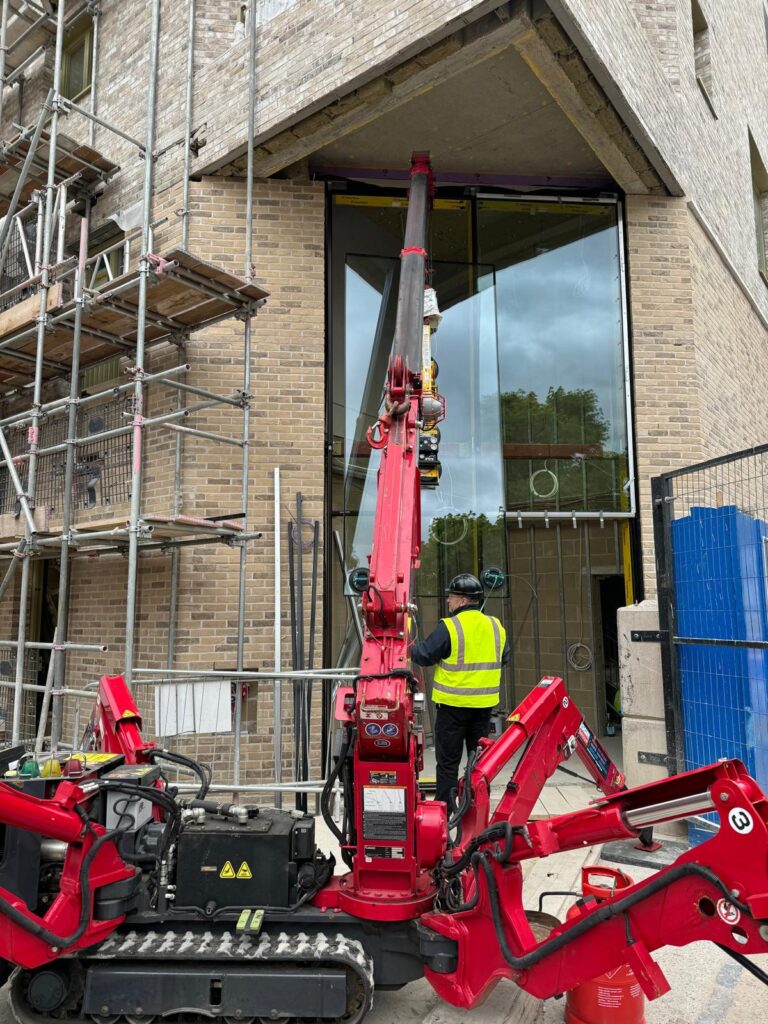 UNIC URW-295 Mini Spider Crane installing curtain walling glazing in London.