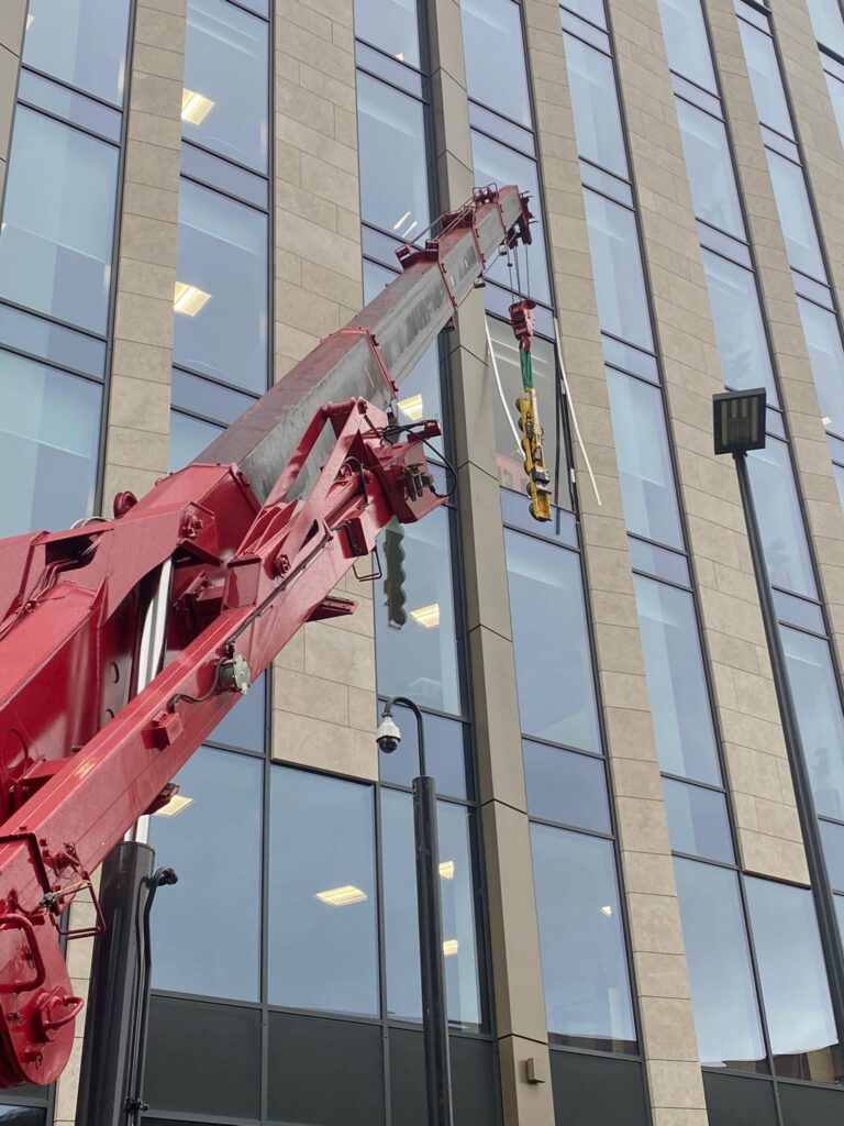 The UNIC URW-1006 Mini Spider Crane installing glazing. Providing precision and efficiency for glazing projects.