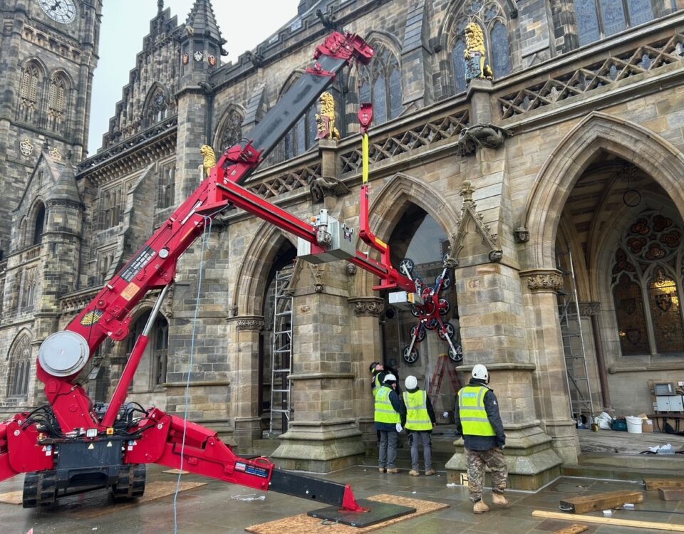 UNIC URW-706 Mini Spider Crane lifting glazing for archway reveals at Rochdale Town Hall.