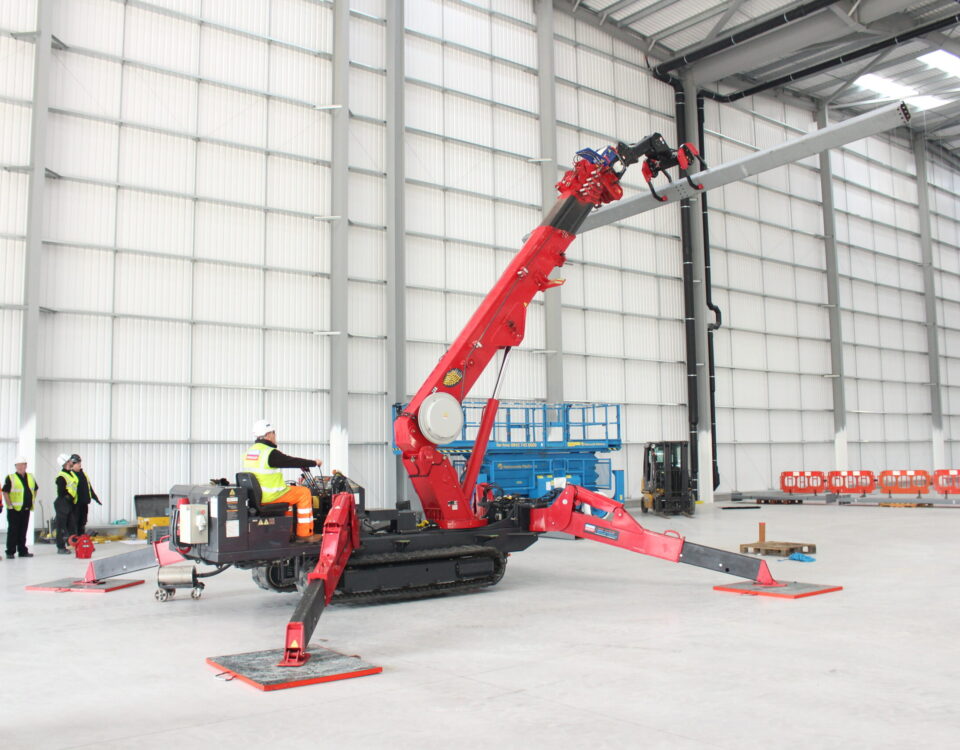UNIC URW-706 Mini Spider Crane with MultiGrab attachment providing better lifting in urban construction.