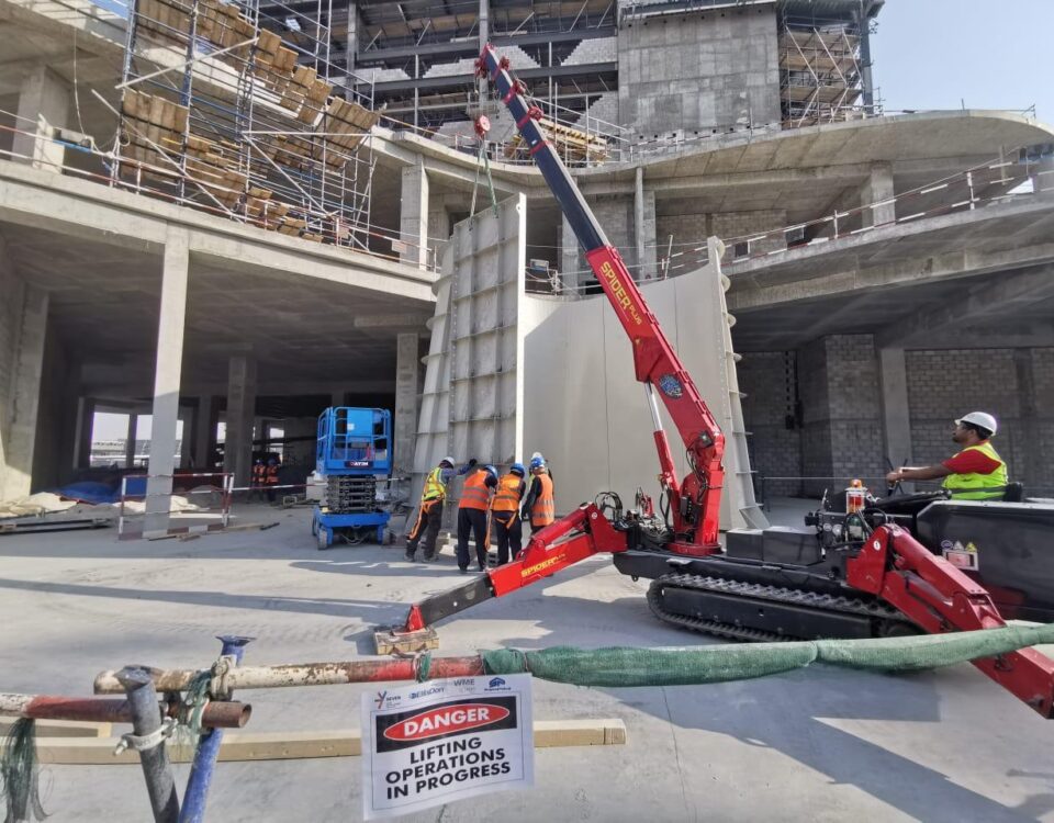 The URW-376 Mini Spider Crane lifting large cladding sections for an entertainment centre.