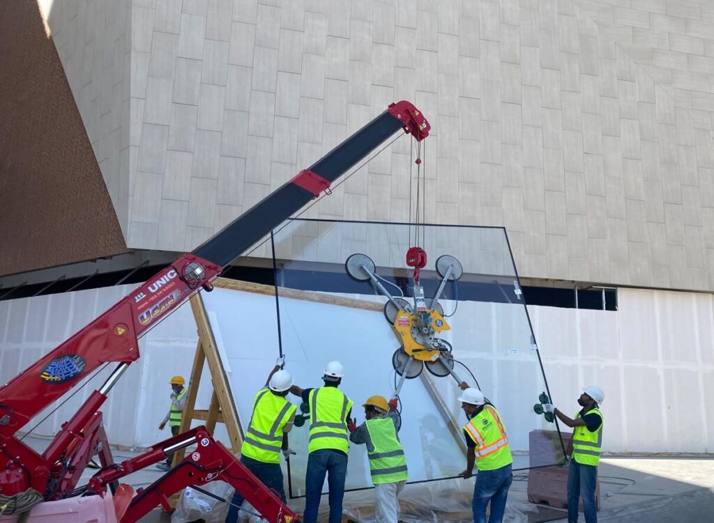 A UNIC URW-295 Mini Spider Crane installing oversized glazing inside Solitaire Mall.